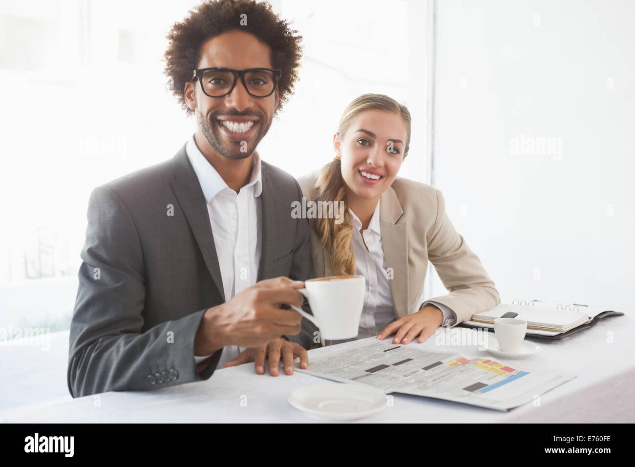 Business people having coffee smiling at camera Stock Photo