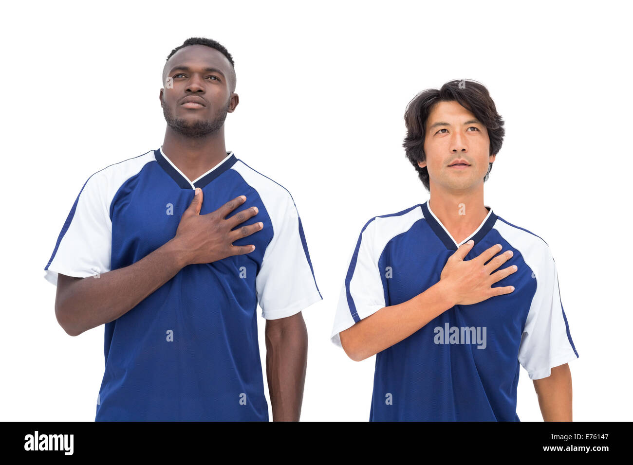 Football players in blue listening to anthem Stock Photo