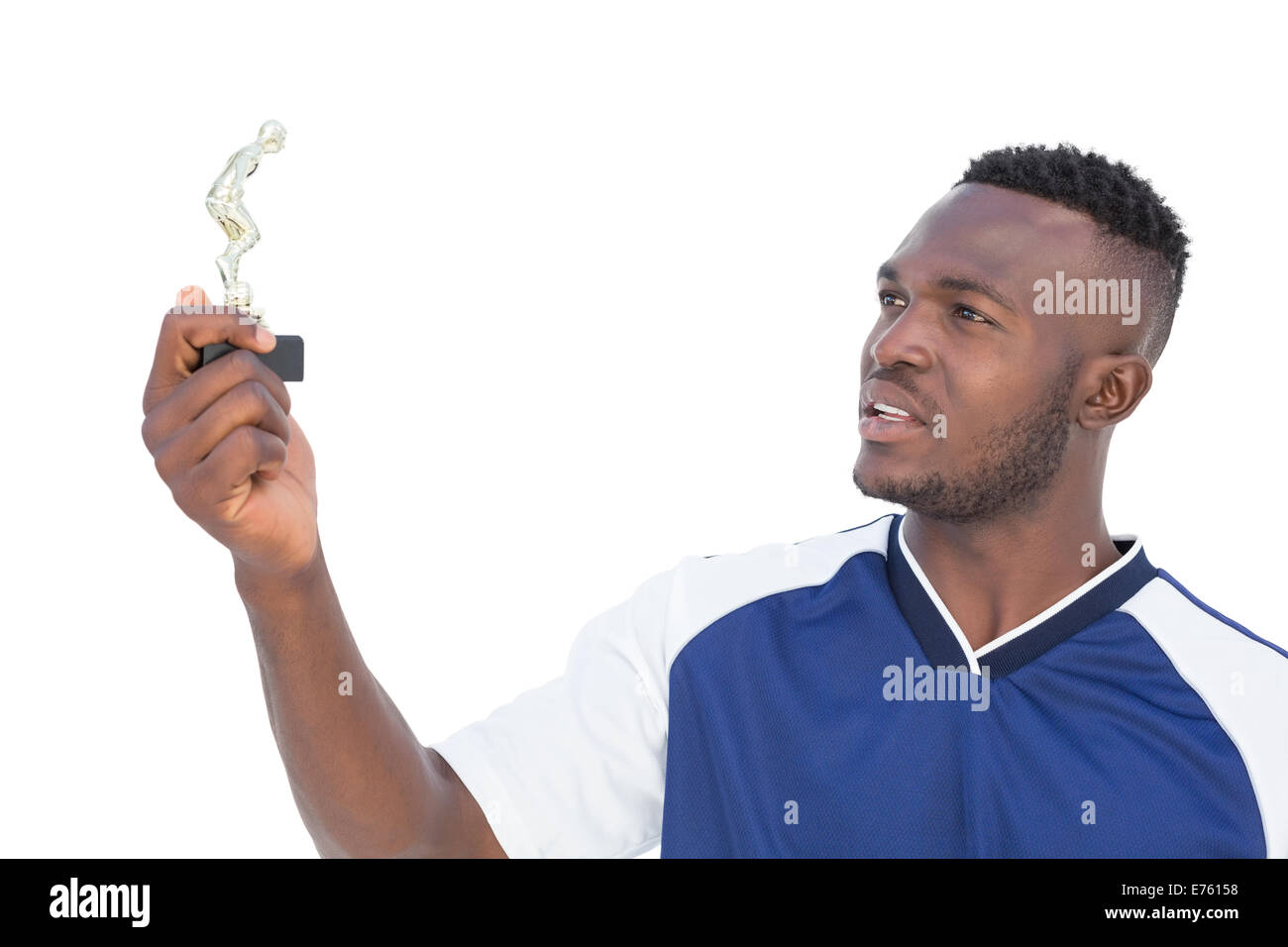 Football player holding winners trophy Stock Photo