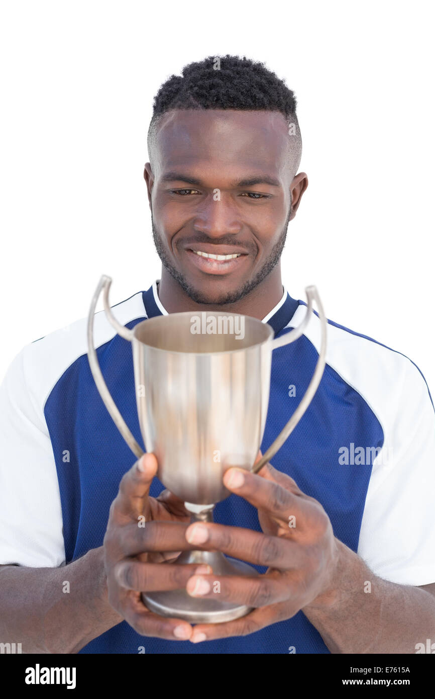 Football player holding winners cup Stock Photo