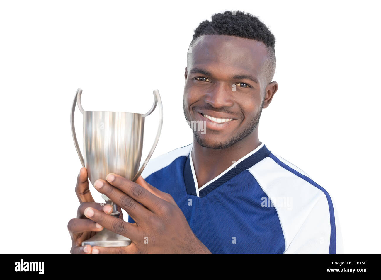 Football player holding winners cup Stock Photo