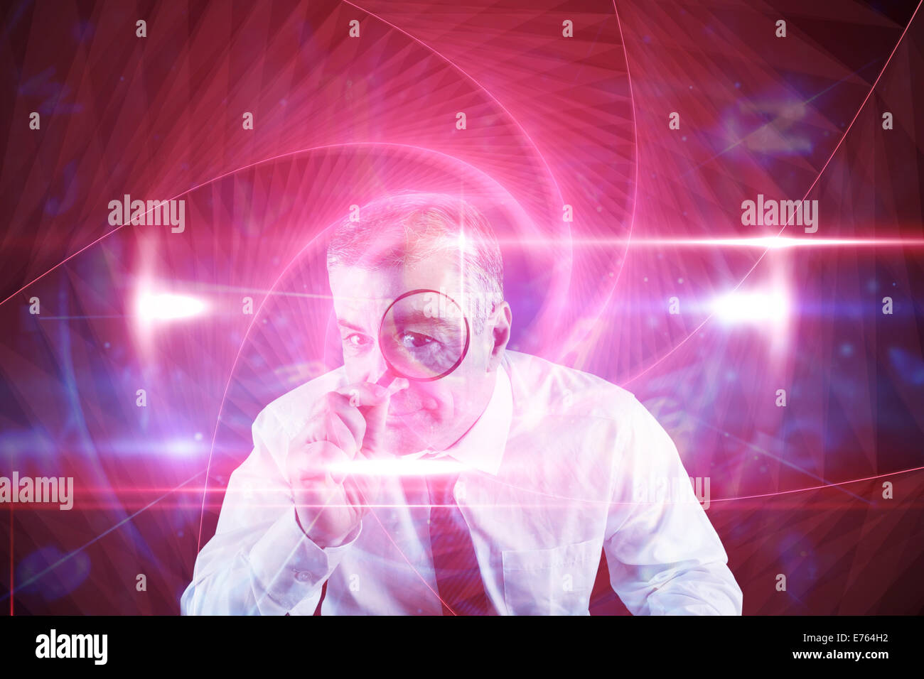 Composite image of focused businessman with magnifying glasses Stock Photo