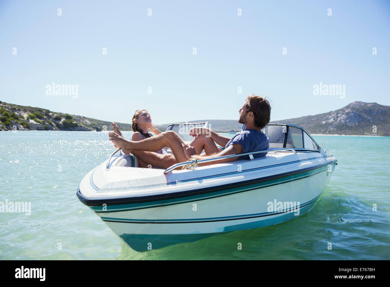 Couple sitting together in boat on water Stock Photo