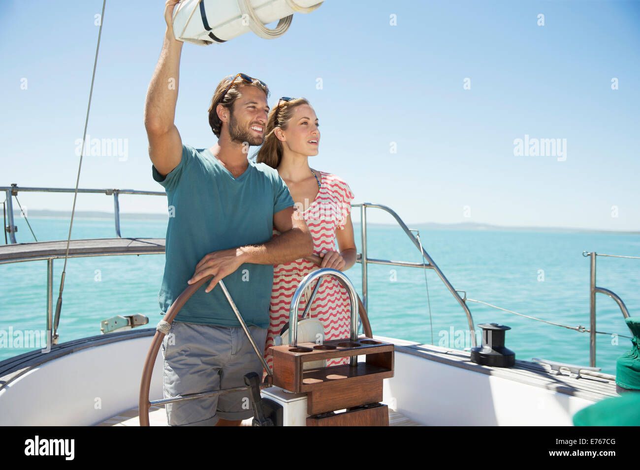 Couple steering boat together Stock Photo