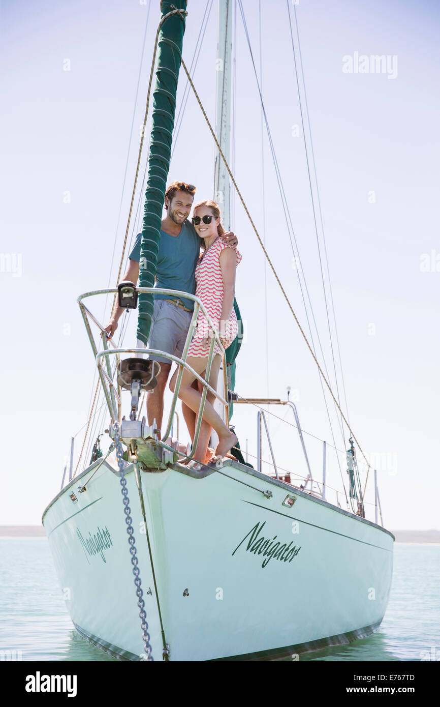 Couple standing on front of boat Stock Photo