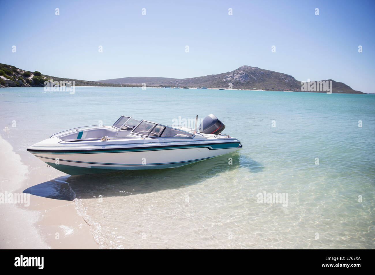 Speedboat beached on shore Stock Photo