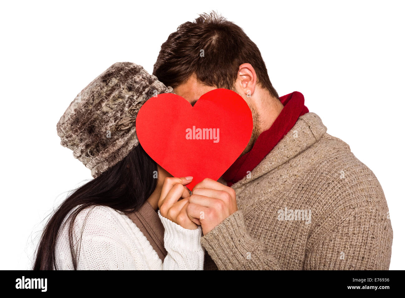 Young couple kissing behind red heart Stock Photo - Alamy
