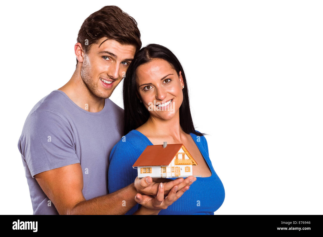 Young couple holding a model house Stock Photo - Alamy