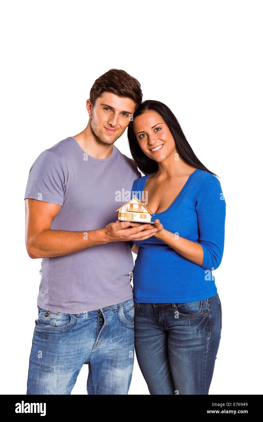 Young couple holding a model house Stock Photo - Alamy