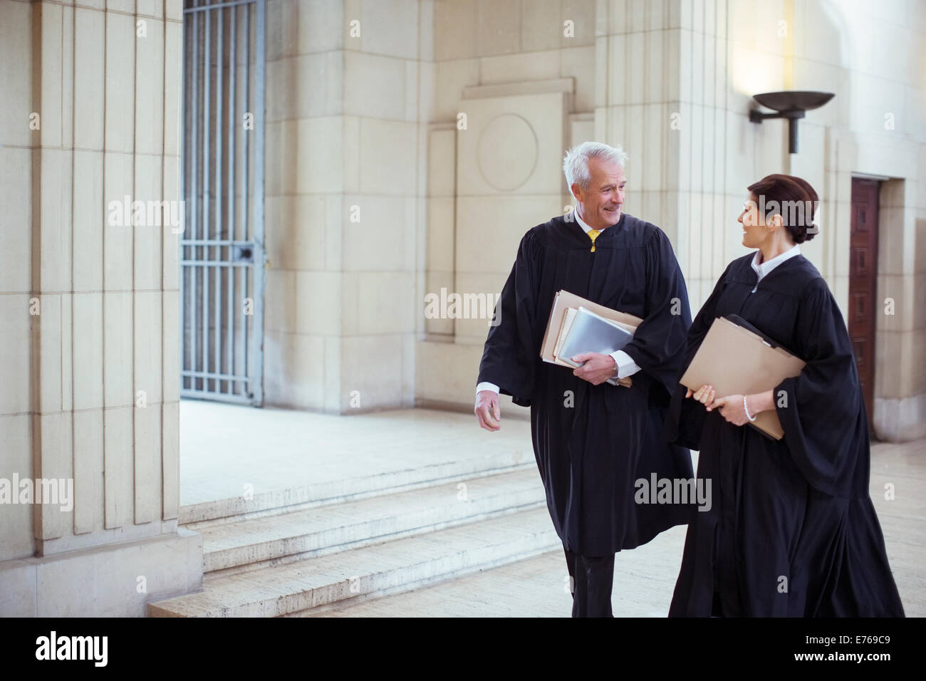 Judges walking through courthouse together Stock Photo