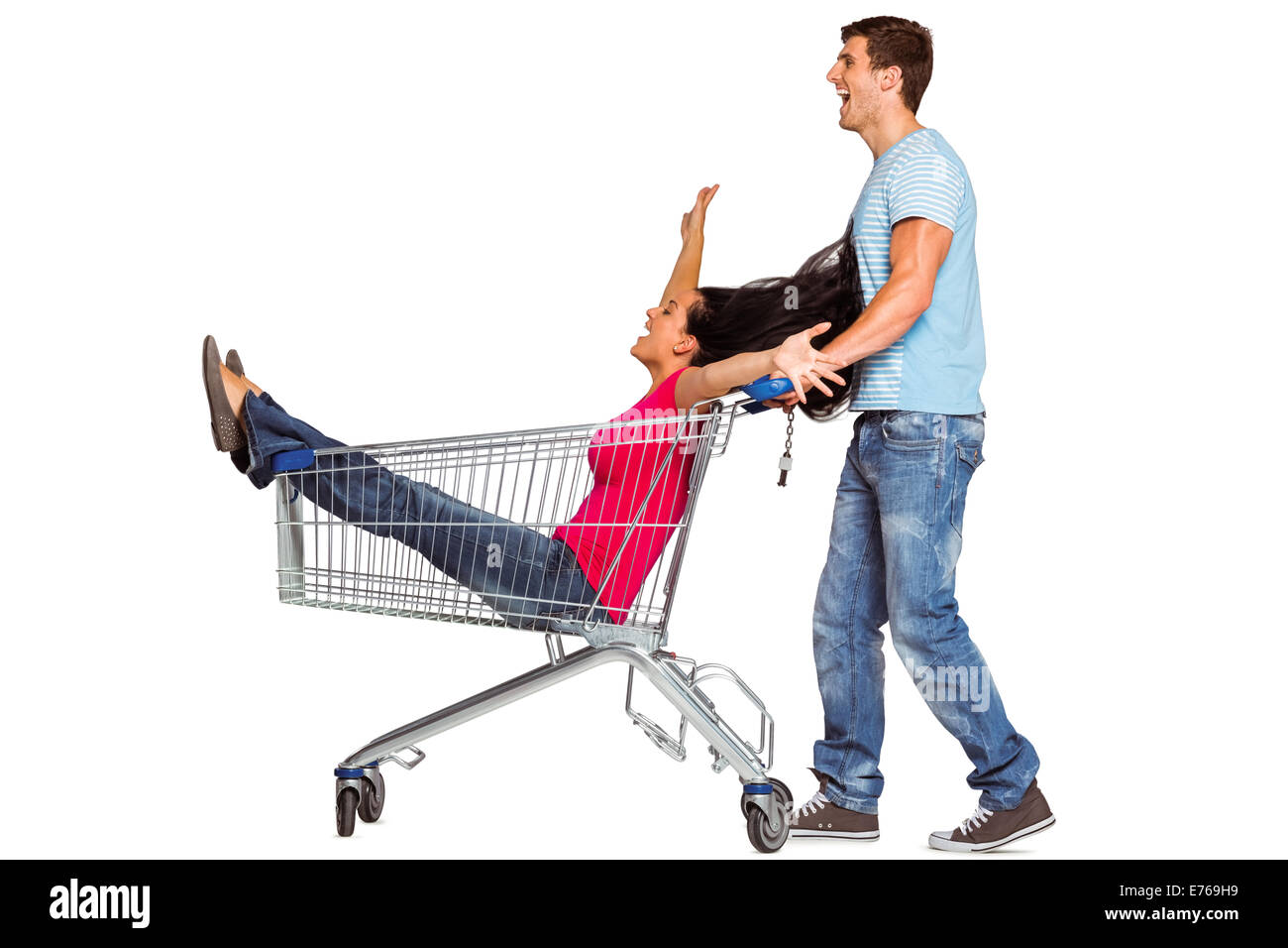 Young couple having fun with shopping cart Stock Photo