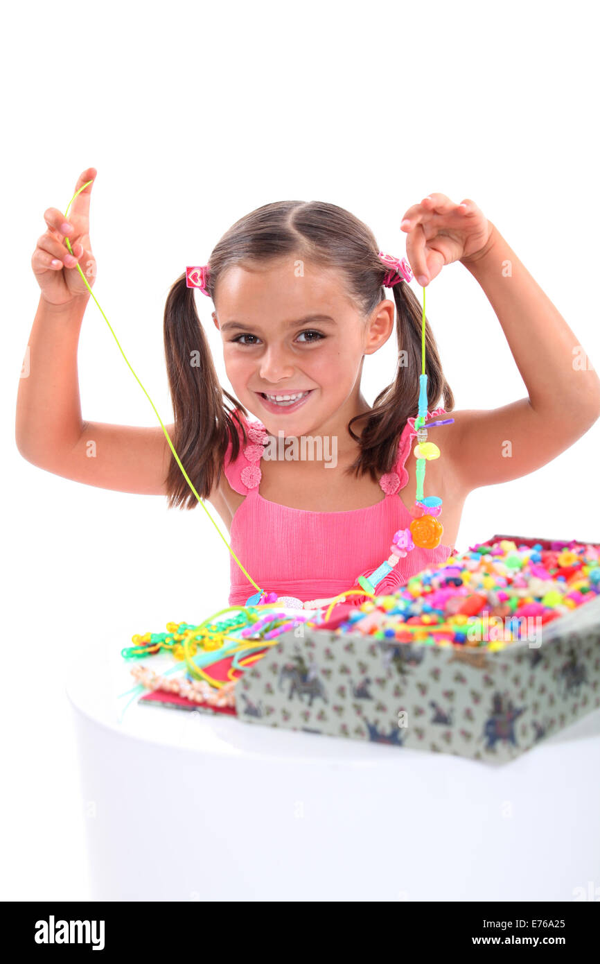 Girl making a bead necklace Stock Photo Alamy