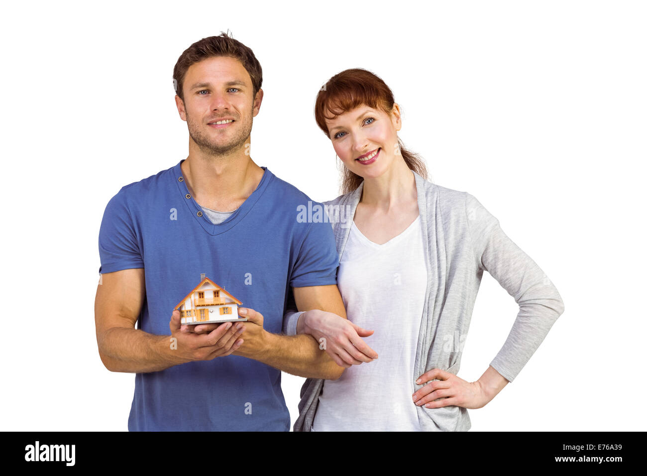 Couple holding a model house Stock Photo - Alamy