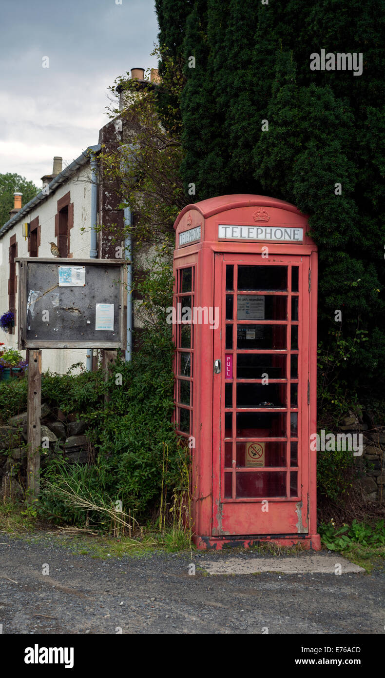 A community news bulletin board next to the village phone box at Traquair, Scotland. Stock Photo