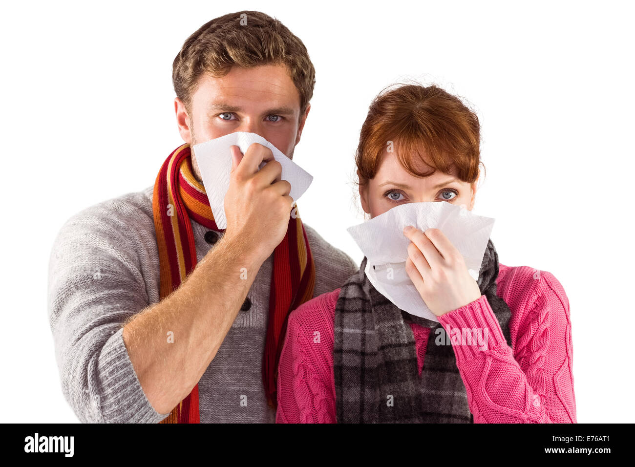 Couple blowing noses into tissues Stock Photo