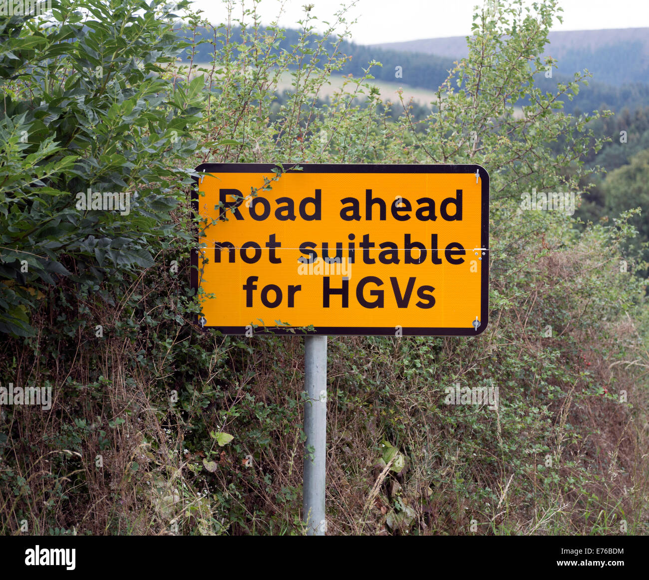 A sign on a country road warning that the route  is impassable for large vehicles. Stock Photo