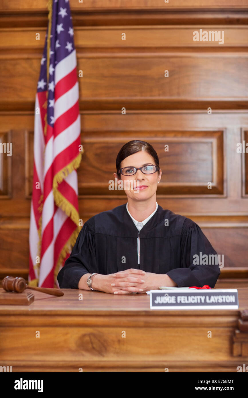 Judge sitting at judges bench in court Stock Photo
