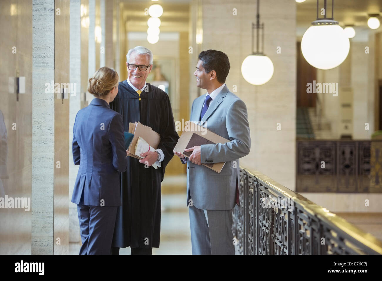Judge and lawyers talking in courthouse Stock Photo
