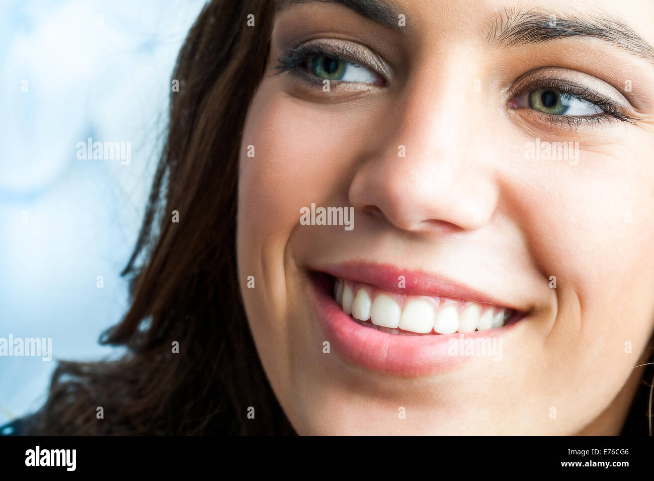 Close up beauty portrait of girl with charming smile looking aside. Stock Photo