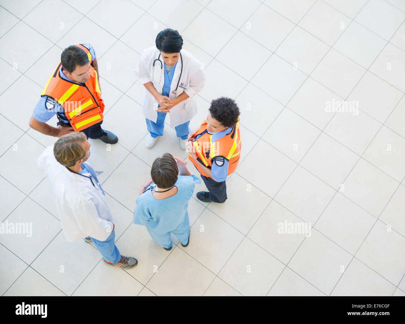Doctors, nurses, and paramedics talking in hospital Stock Photo
