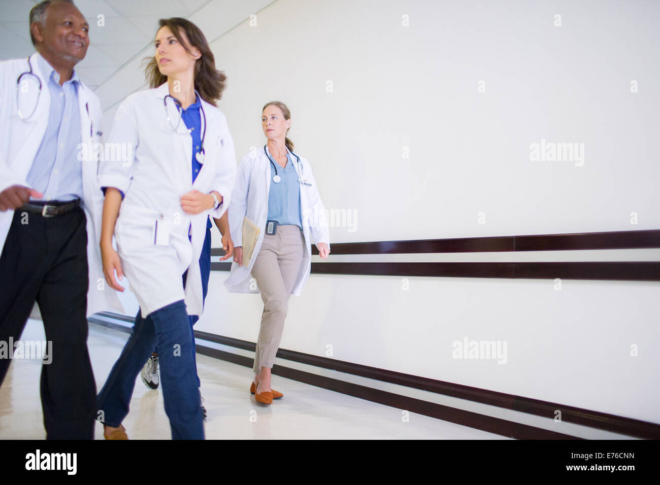 Doctors and nurses in hospital hallway Stock Photo