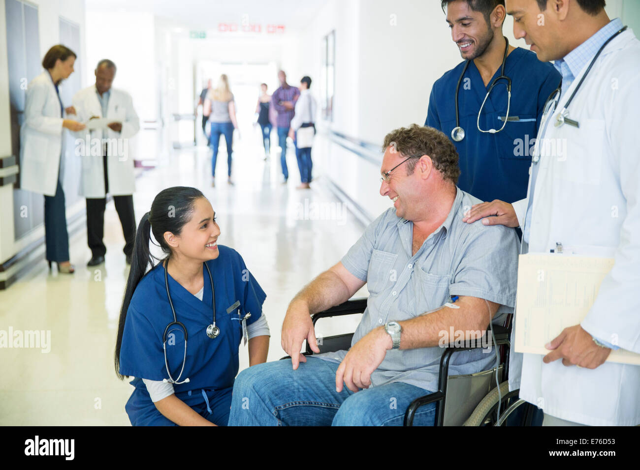 Doctor and nurses talking to patient in hospital Stock Photo