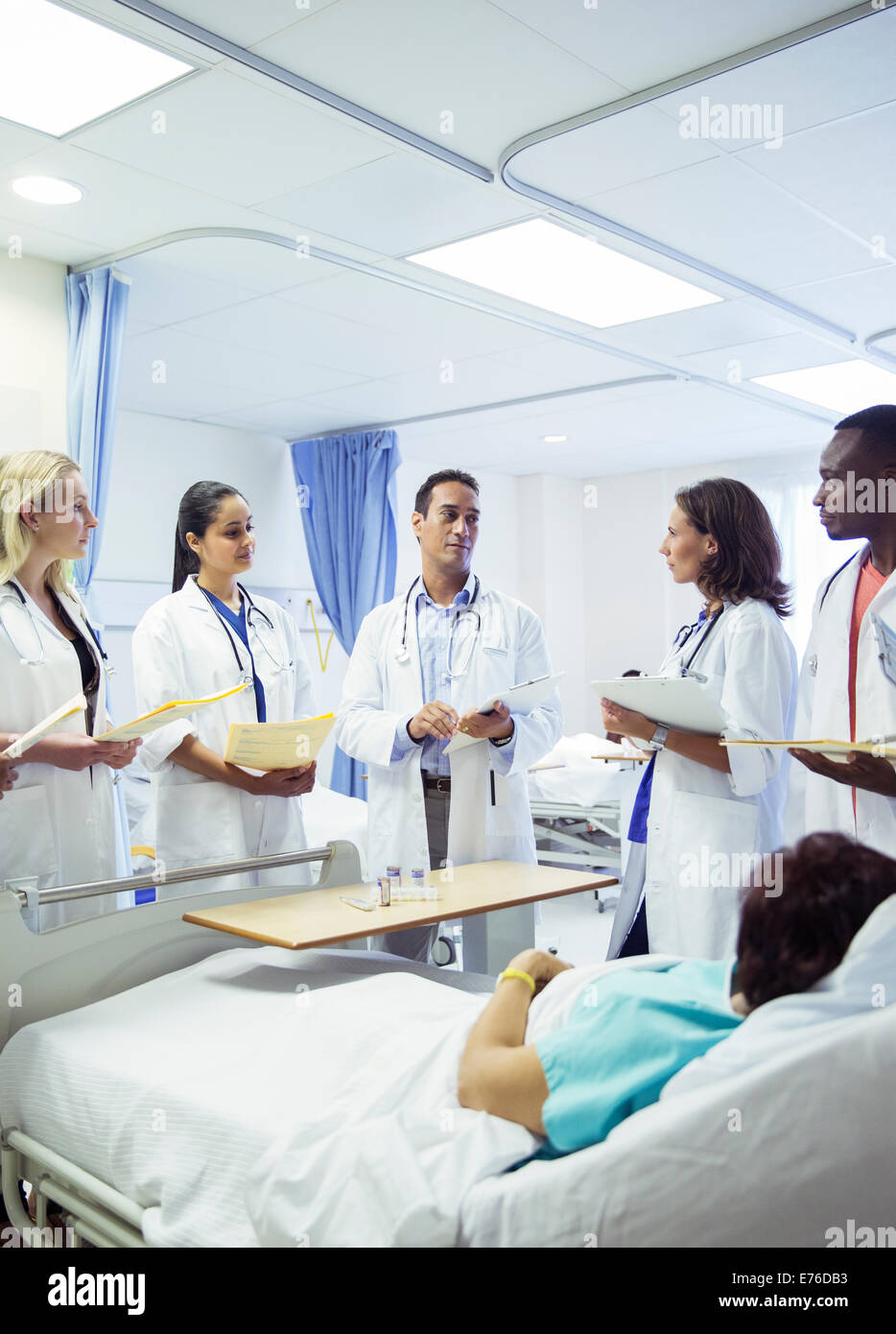 Doctor teaching residents in hospital room Stock Photo