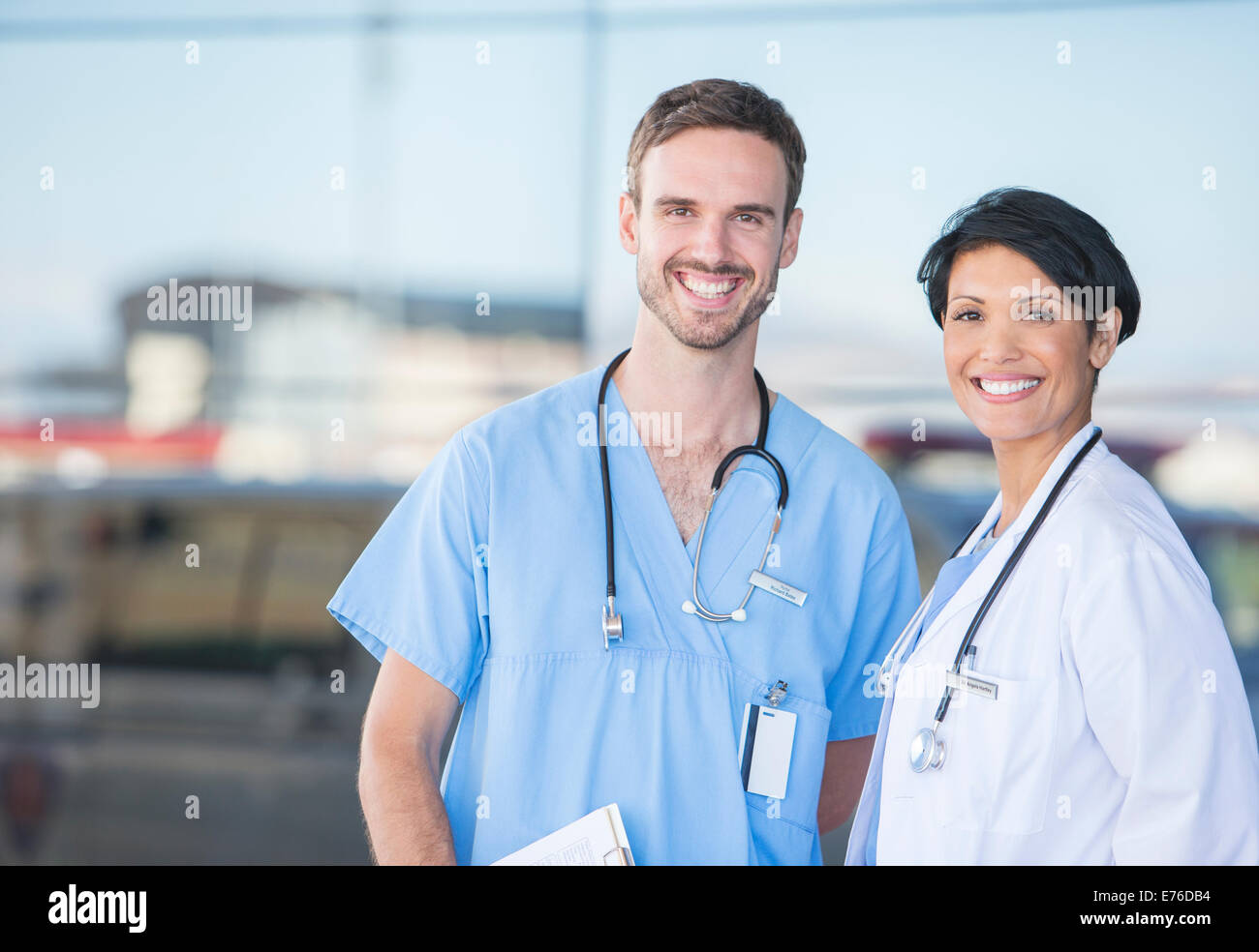 Doctor and nurse smiling outdoors Stock Photo