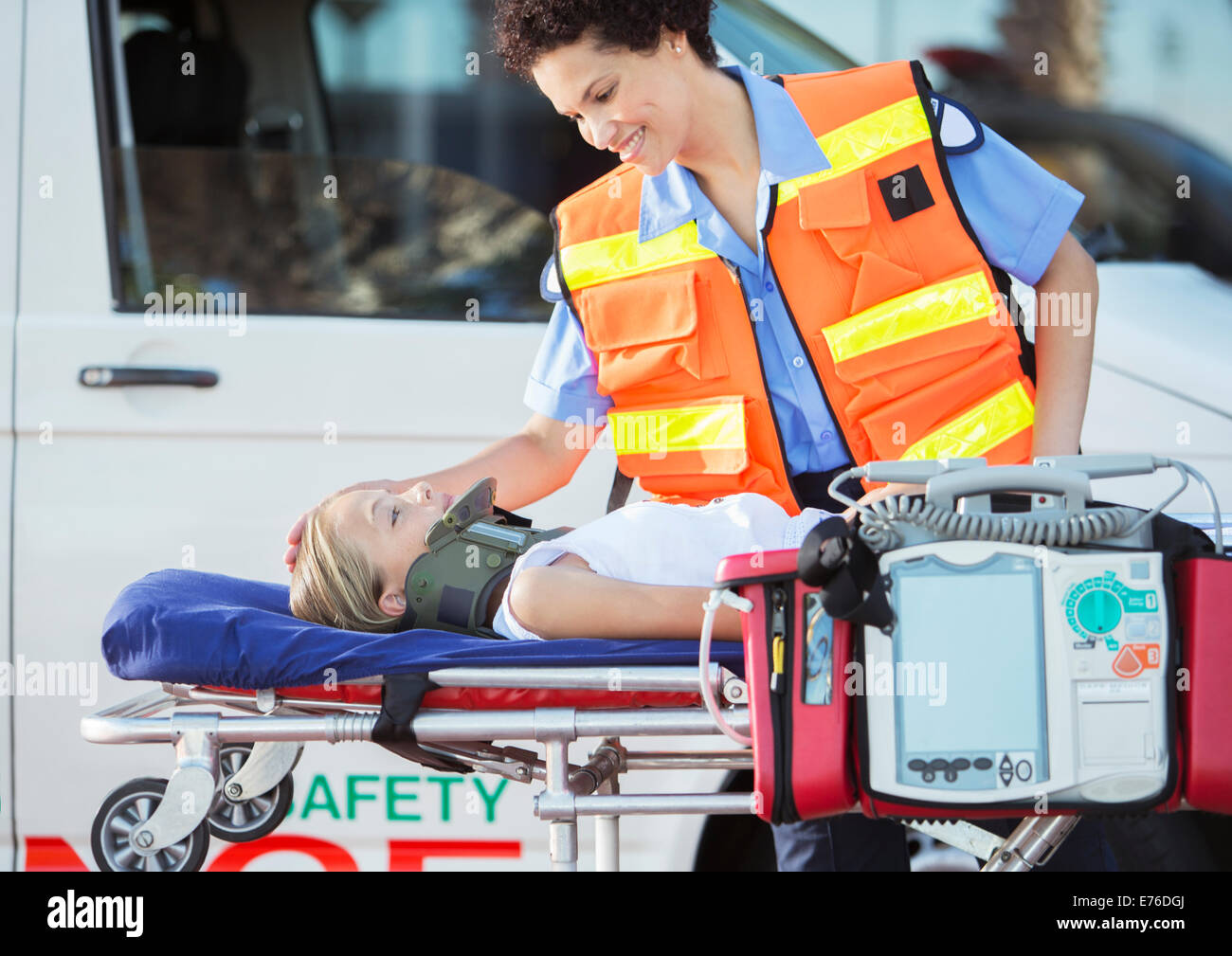 Paramedic examining patient on stretcher Stock Photo