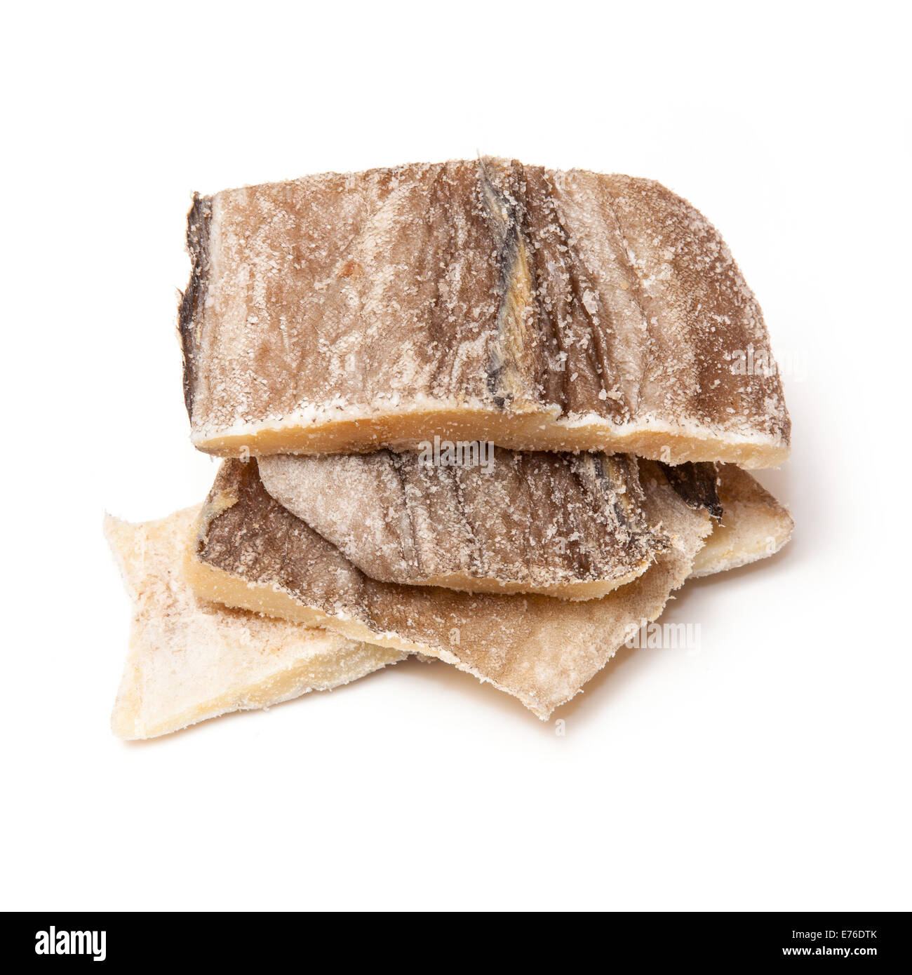 Pieces of salt cod fish isolated on a white studio background Stock