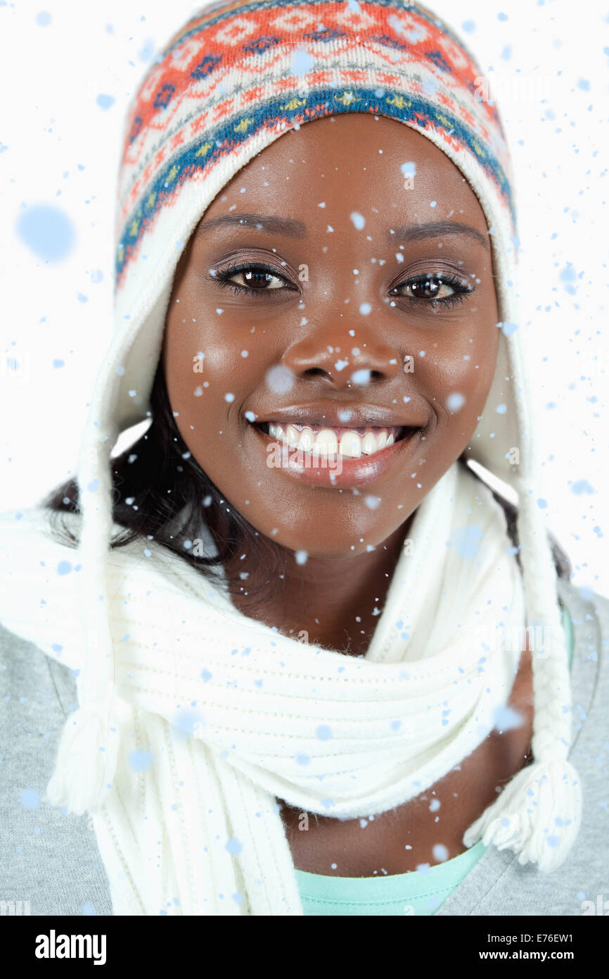 Composite image of close up of smiling woman with winter hat on Stock Photo