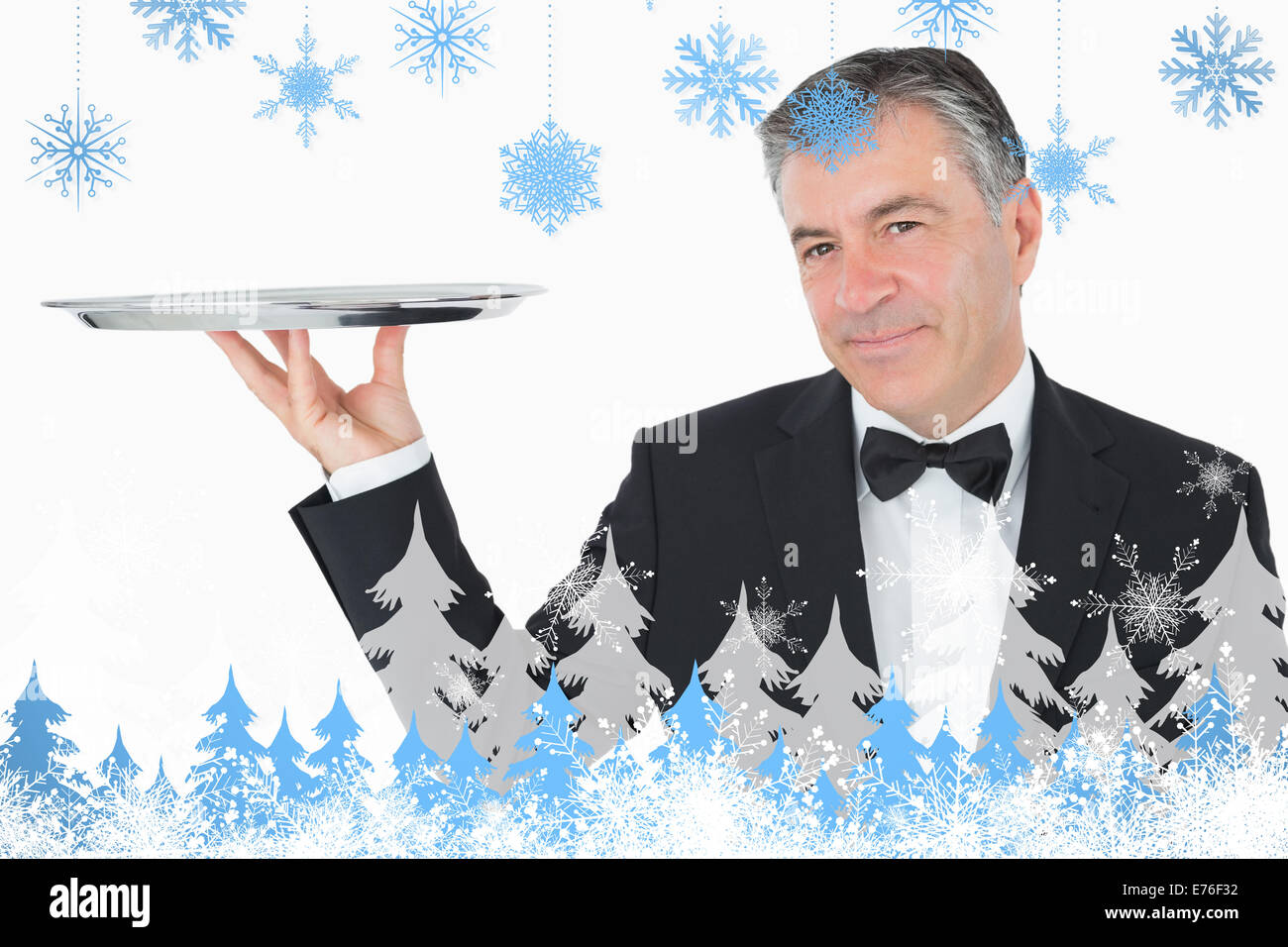 Composite image of welldressed waiter holding a silver tray Stock Photo