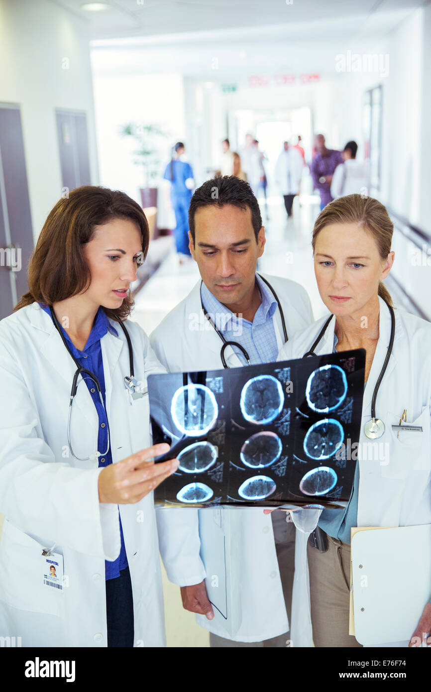 Doctors examining xrays in hospital hallway Stock Photo Alamy