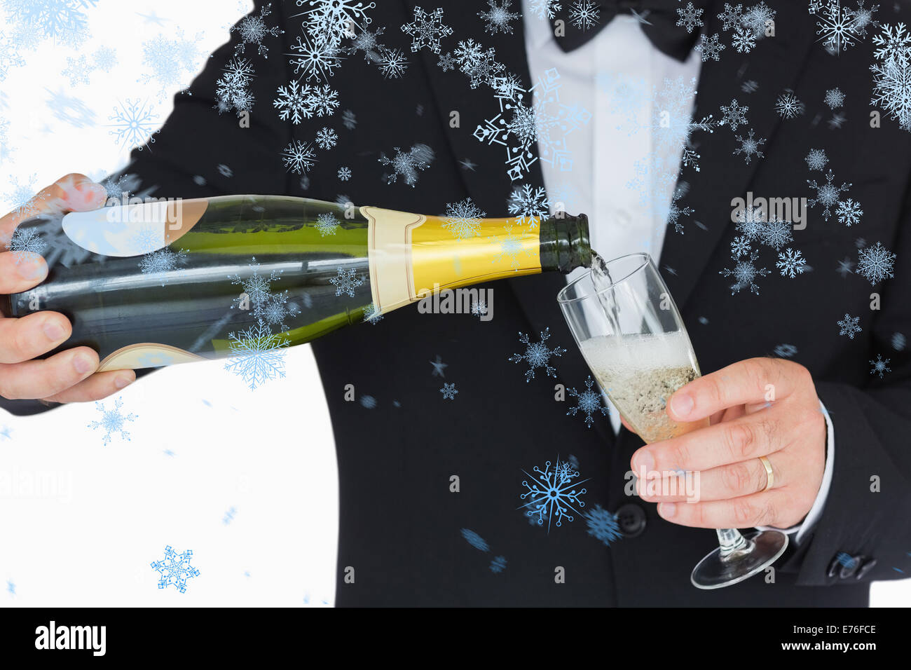 Composite image of welldressed man pouring champagne Stock Photo