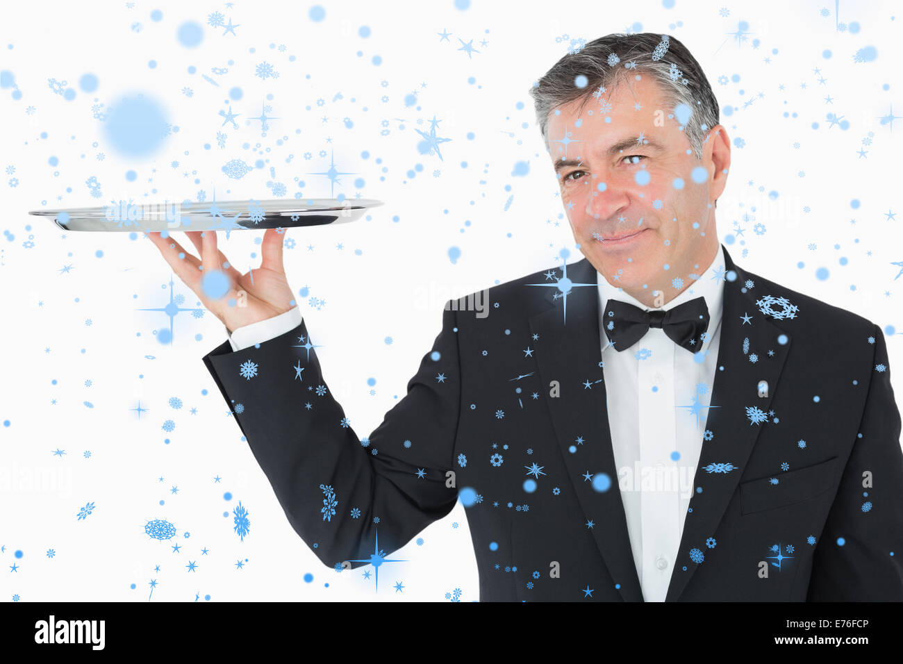 Composite image of welldressed waiter holding a silver tray Stock Photo