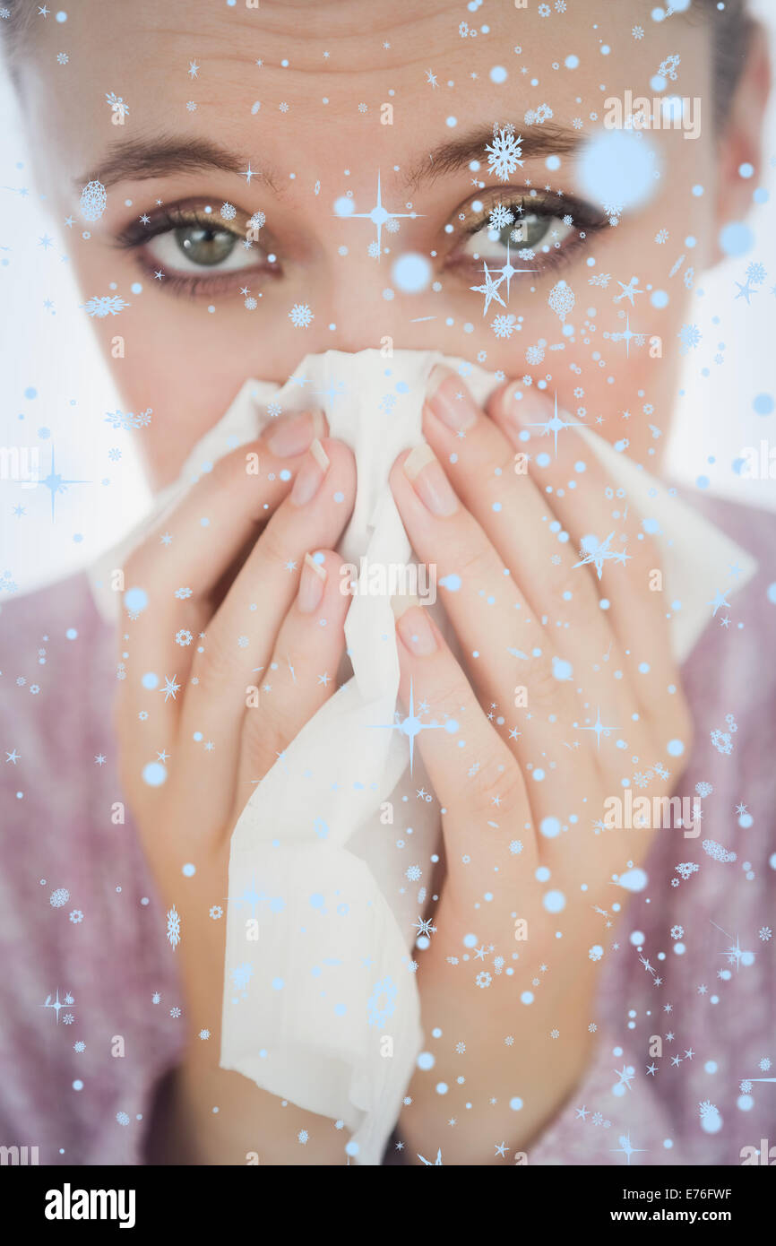 Composite image of unhappy young woman suffering from cold Stock Photo