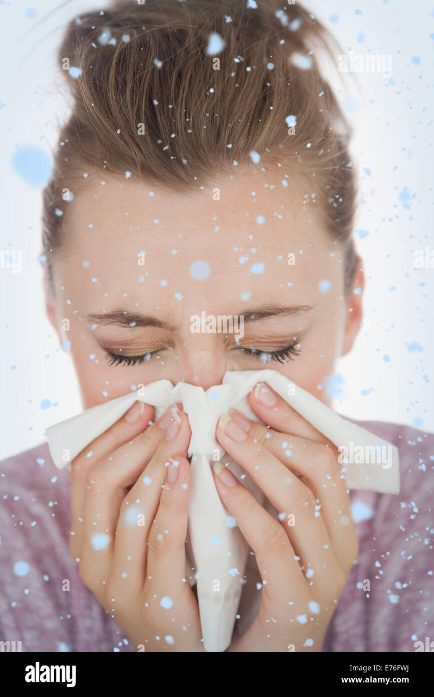 Composite image of woman blowing nose Stock Photo
