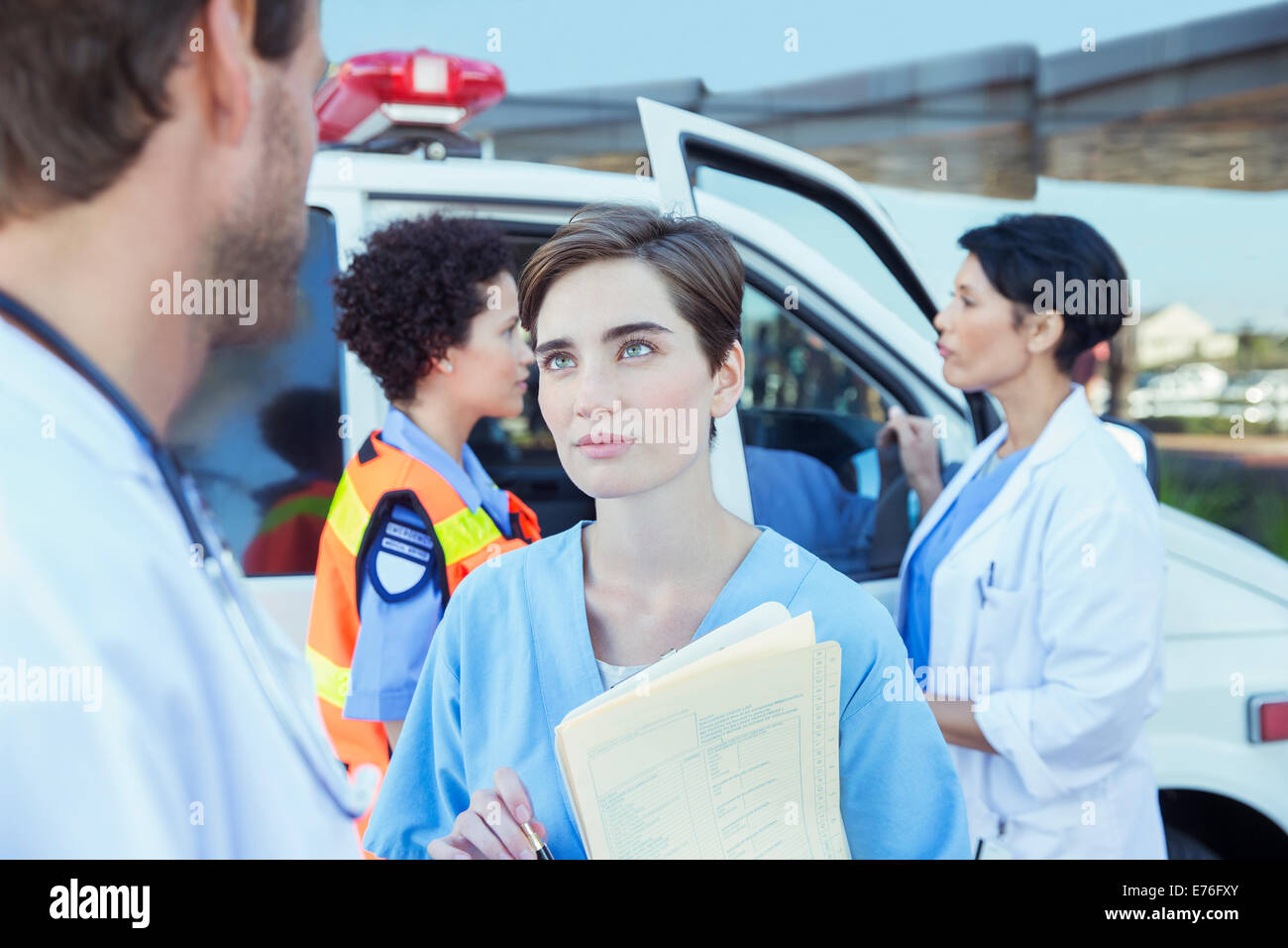 Doctor and nurse talking outside hospital Stock Photo