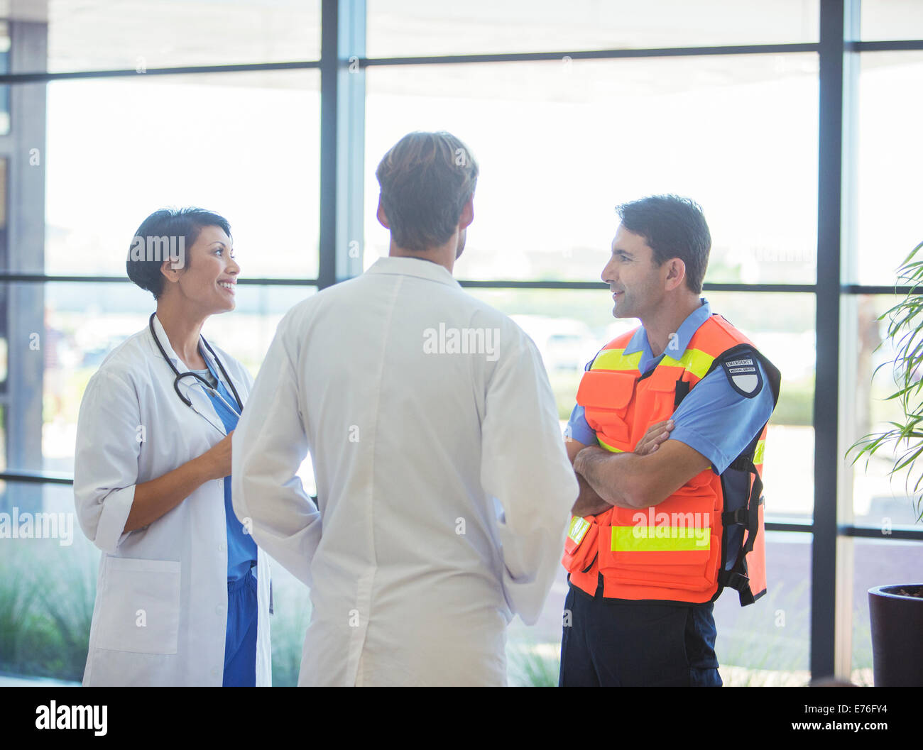 Doctors and paramedic talking in hospital Stock Photo