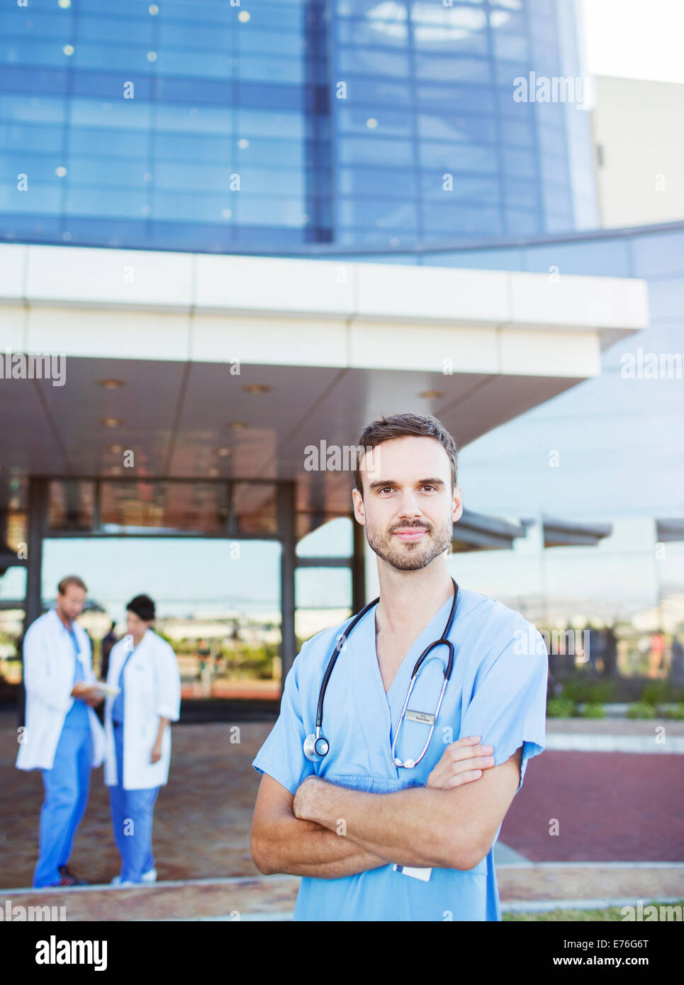 Nurse standing outside hospital Stock Photo