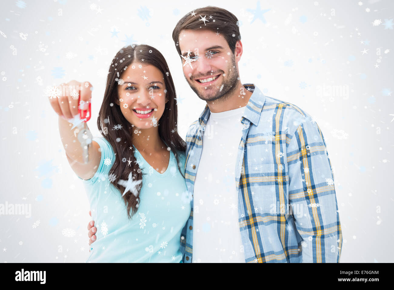 Composite image of happy young couple showing new house key Stock Photo ...