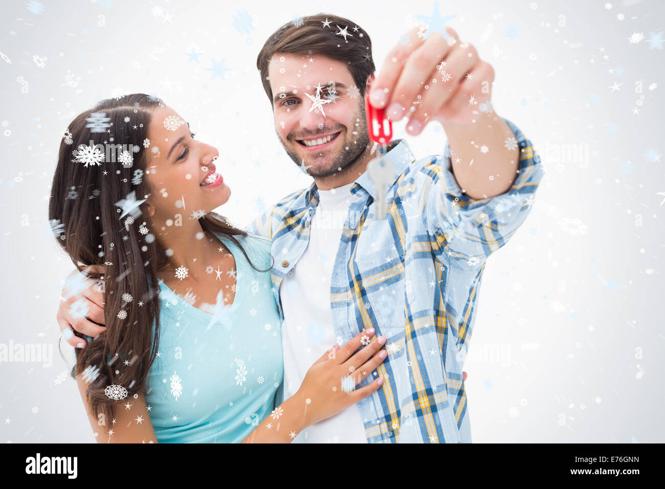 Composite image of happy young couple showing new house key Stock Photo ...