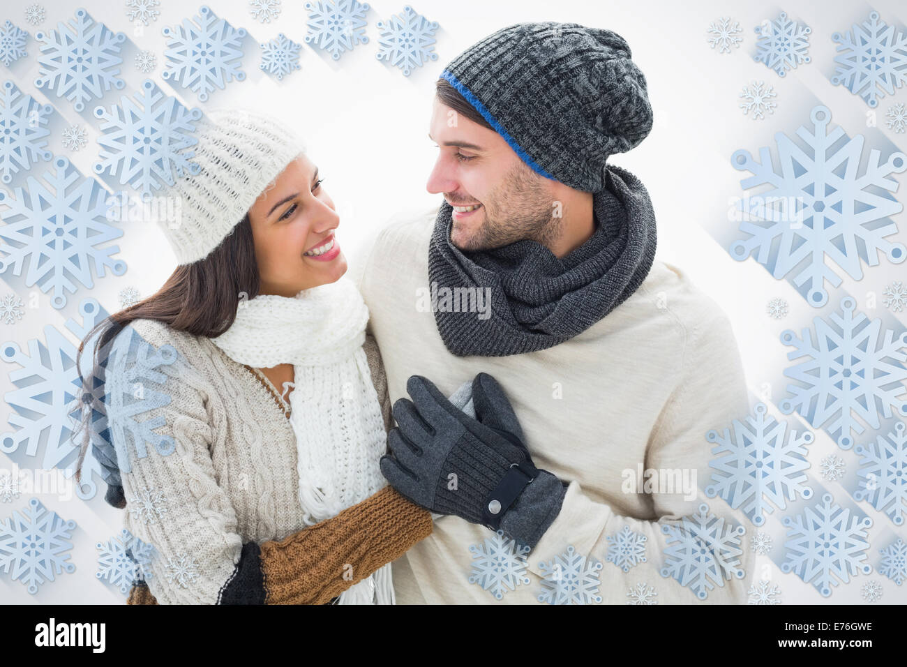 Composite image of attractive young couple in warm clothes Stock Photo ...