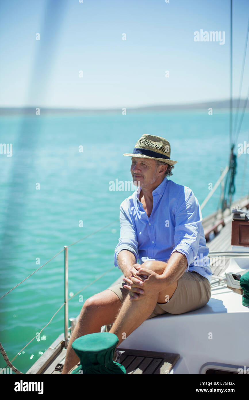 Older man sitting on boat outdoors Stock Photo