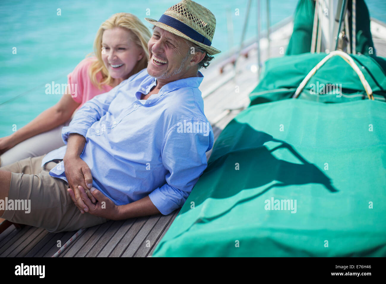 Couple sitting on boat together Stock Photo
