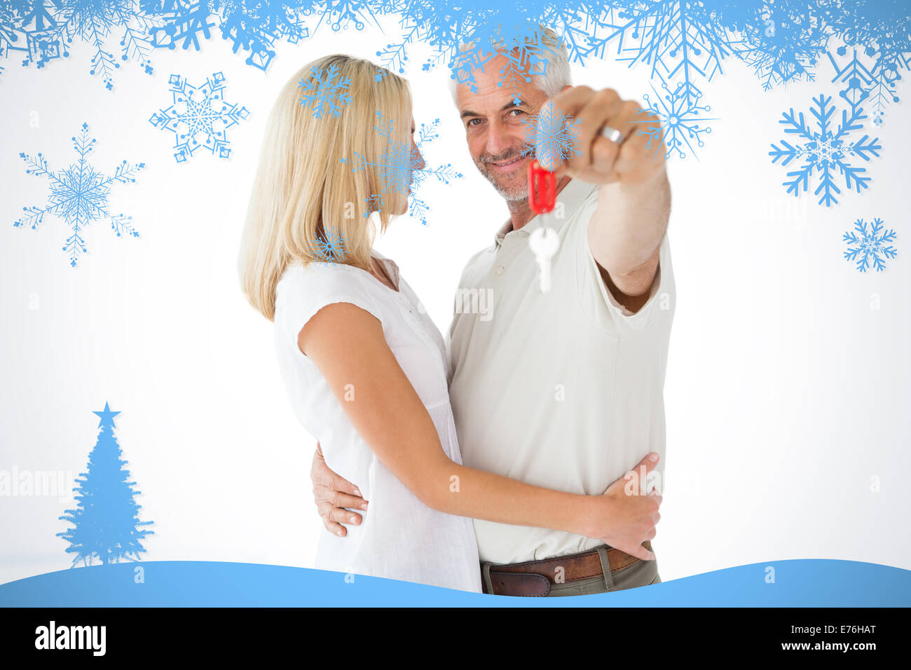 Composite image of happy couple showing their new house key Stock Photo ...