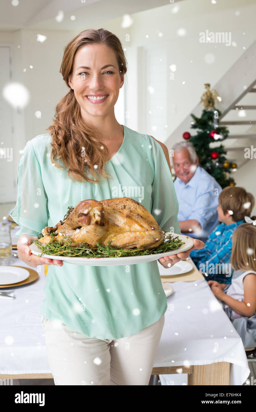 Composite image of happy mother with christmas meal Stock Photo