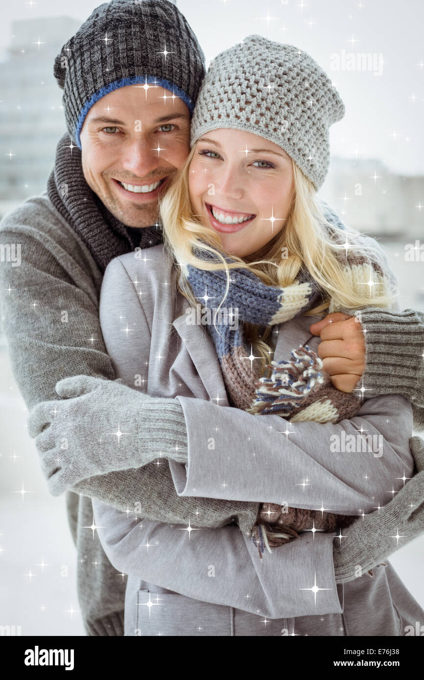 Composite image of cute couple in warm clothing smiling at camera Stock ...