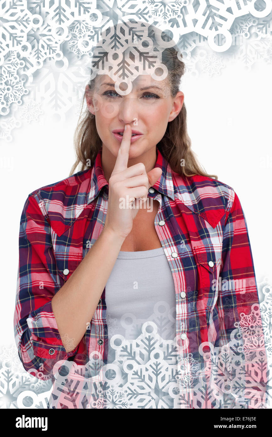 Composite image of portrait of a smiling woman asking for silence Stock Photo