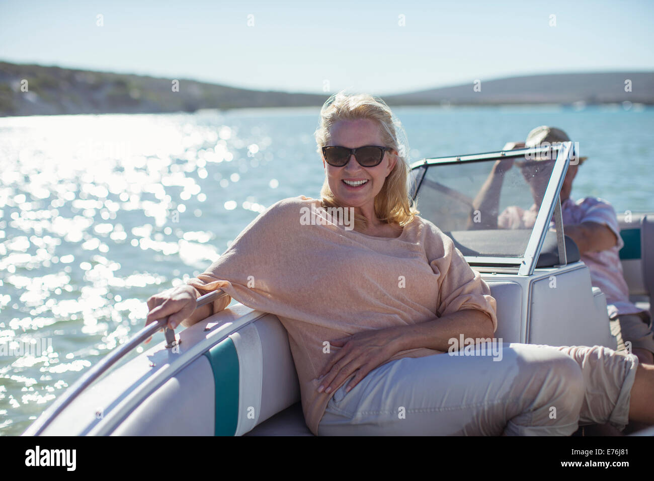 Older woman sitting in boat on water Stock Photo